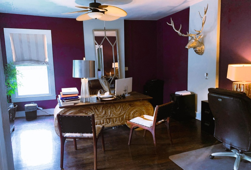 Office with wood finished floors and ceiling fan