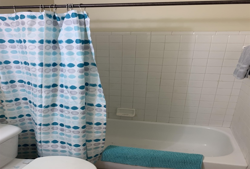 Bathroom featuring shower / tub combo with curtain