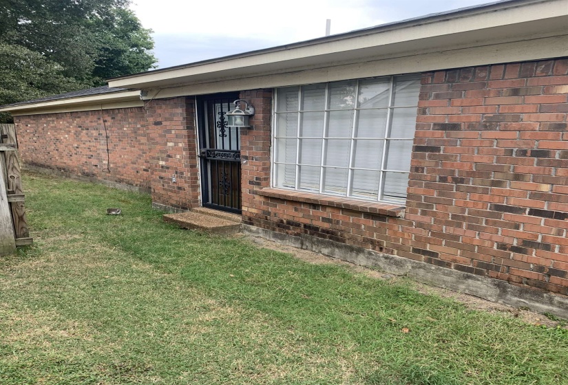 View of front facade featuring brick siding and a front yard