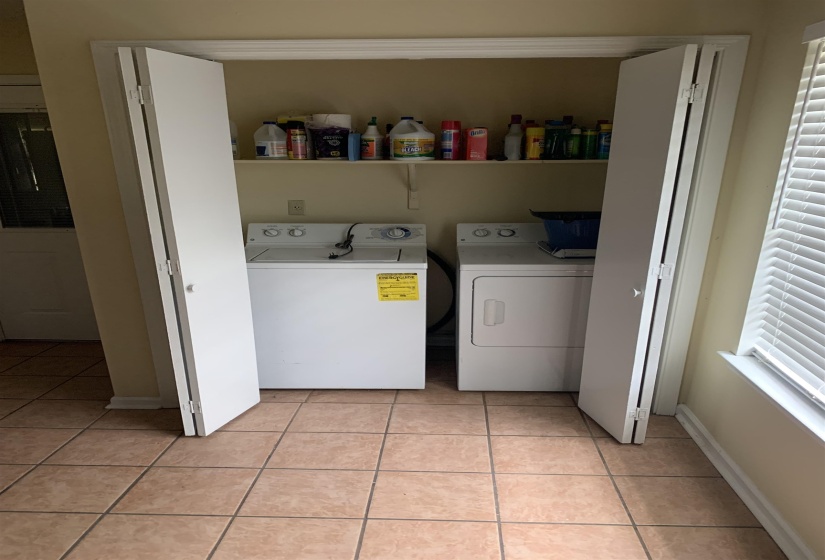 Washroom featuring light tile patterned floors and separate washer and dryer