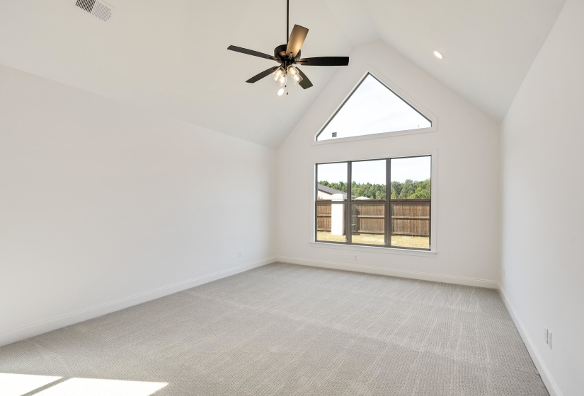 Massive primary bedroom with vaulted ceilings and cathedral style windows!