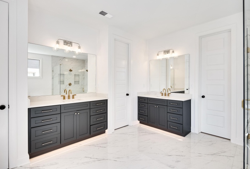 Separate, double vanities with toe kick lighting.