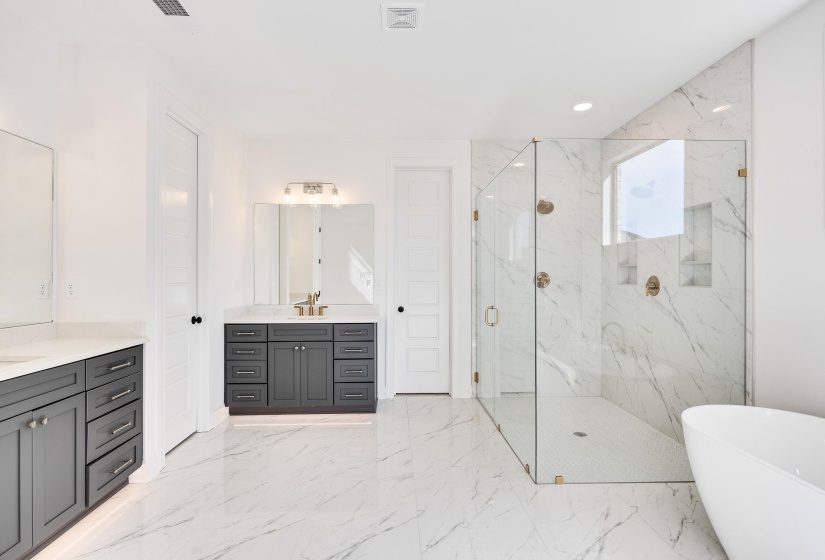 Luxurious, spa like bathroom with beautiful tile floors.