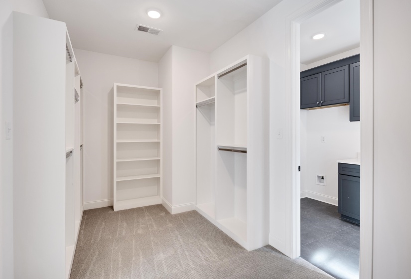 Another view of the primary closet, with direct access to the laundry room.