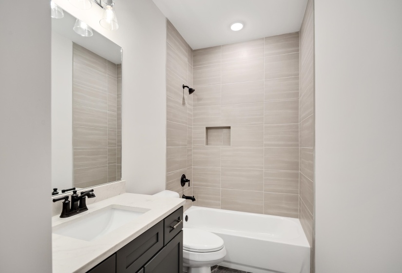 Bathroom 2 is a shared hall bathroom with tile floors and a shower/tub combination.