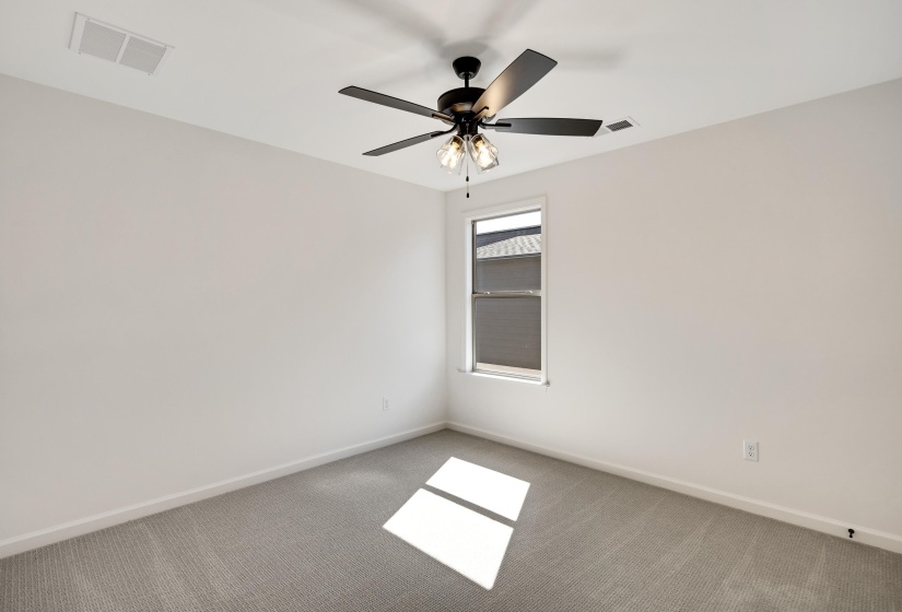 Bedroom 3 is upstairs with carpet, ceiling fan and a walk in closet.