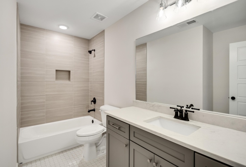 Bathroom 3 is a shared hall bath with tile floors and shower/tub combination.