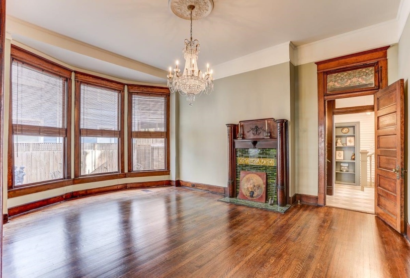 Unfurnished dining area featuring wood finished floors, a chandelier, and ornamental molding