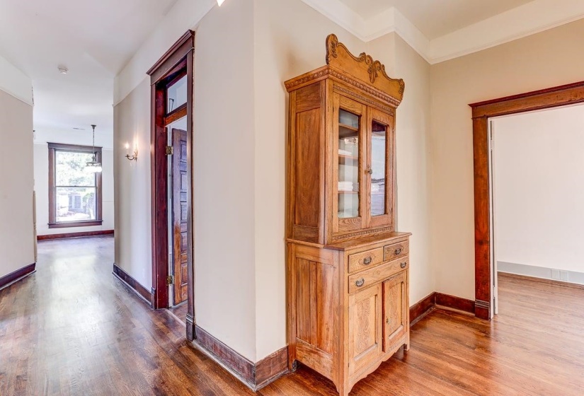 Corridor with wood finished floors and baseboards