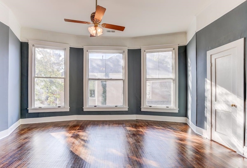 Unfurnished room featuring wood finished floors and a ceiling fan
