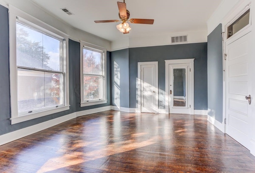 Empty room featuring wood finished floors and ceiling fan