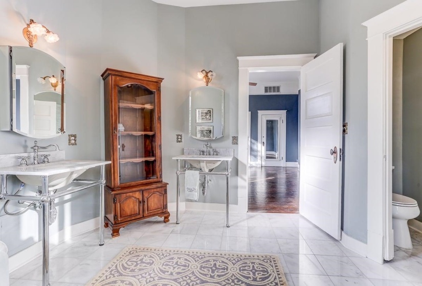 Bathroom featuring baseboards and two sinks