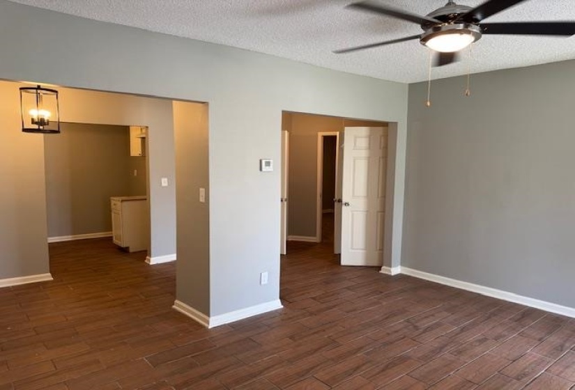Spare room with a ceiling fan, a textured ceiling, and dark wood finished floors