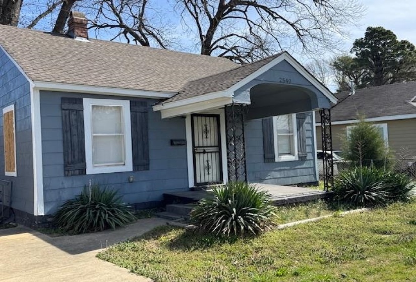 Bungalow-style house with a chimney, fence, and roof with shingles
