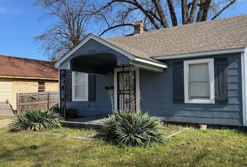 Bungalow with a chimney, fence, a front lawn, and a shingled roof