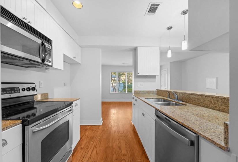 Beautifully updated kitchen featuring new finishes, stainless steel appliances, refreshed flooring, and a stylish breakfast bar. Designed for both function and everyday enjoyment.