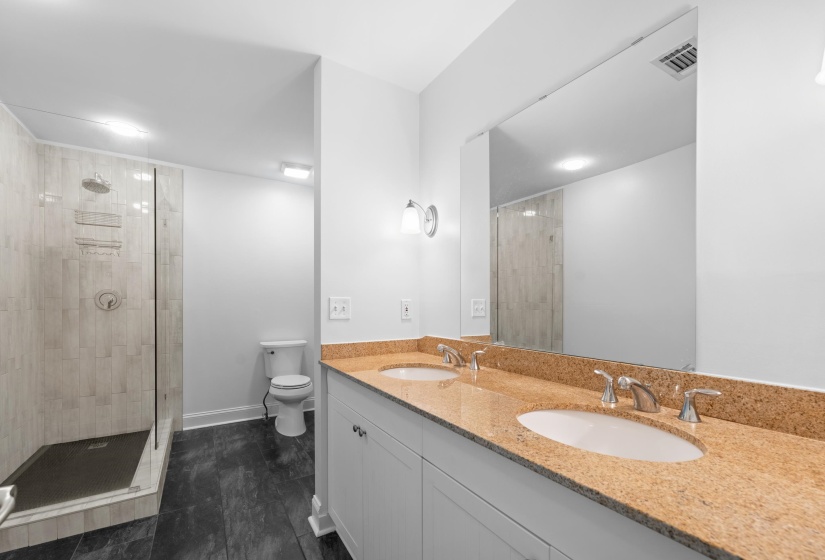 Step into this beautifully updated full bathroom featuring new dual sink vanity, mirrors, flooring, and upgraded fixtures. Modern design meets functionality, creating a bright, clean, and move-in-ready space.