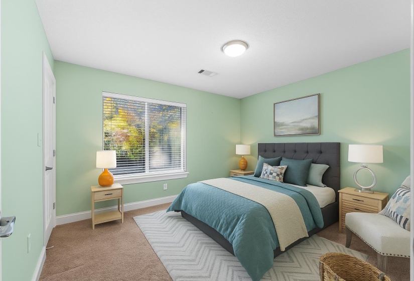 New carpet, soft color palette, and a peaceful setting make this bedroom a restful retreat. Just steps from the updated full bath. This photo has been virtually staged.