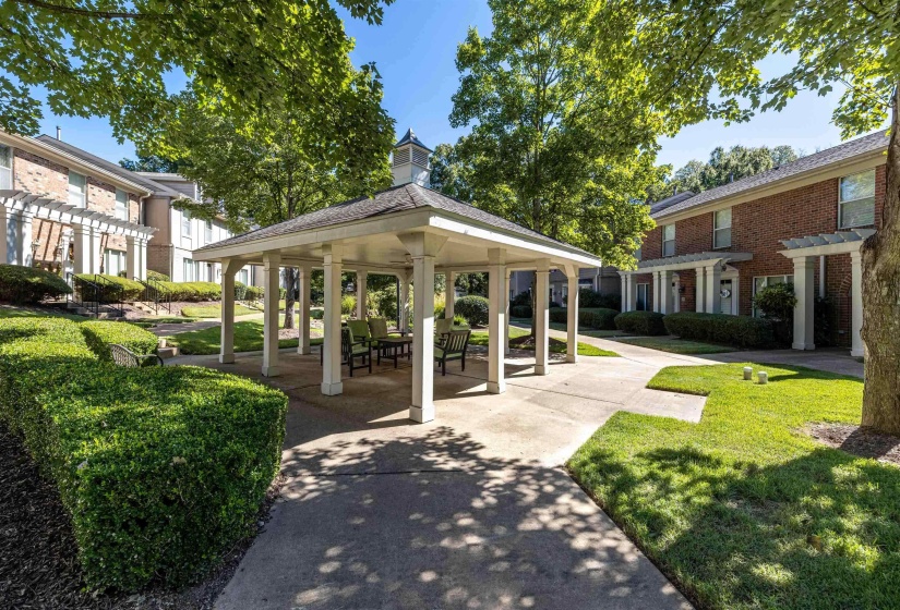 Relax and unwind in the peaceful community courtyard featuring a charming gazebo, surrounded by beautifully maintained landscaping.