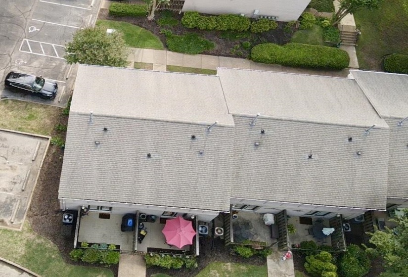 Aerial view highlighting the condo’s desirable end-unit location, offering extra privacy and convenient additional parking.