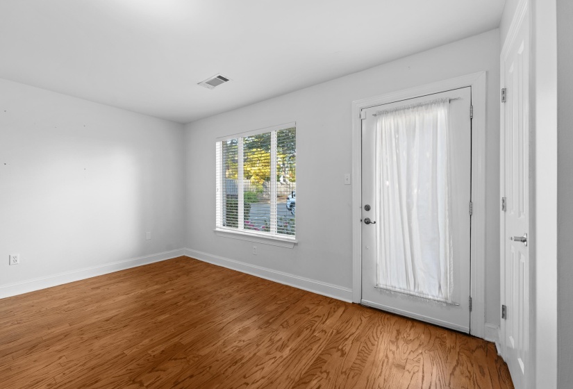 Fresh paint, refinished hardwood floors, and natural light create a warm and welcoming living space perfect for relaxing or entertaining.
