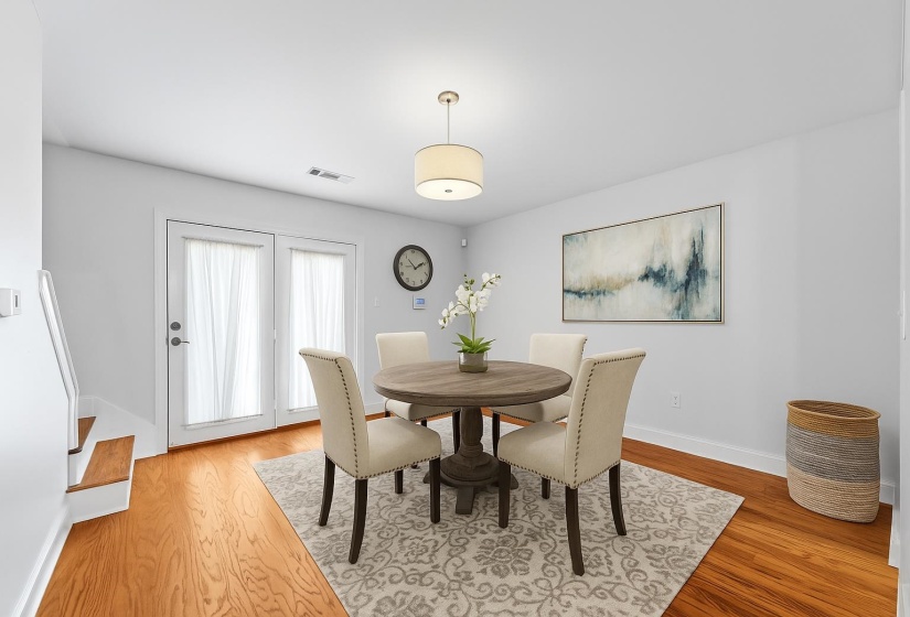 Host family dinners or entertaining guests in this bright, welcoming dining room. The open layout and natural light make every meal feel special, while easy access to the kitchen ensures convenience and flow. This photo has been virtually staged.