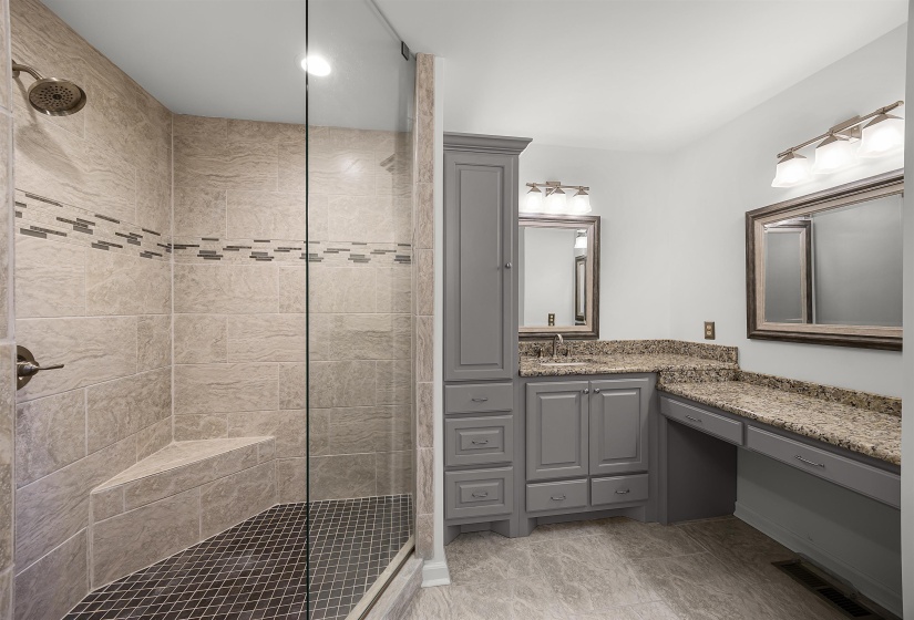 Bathroom featuring vanity, a walk in shower, and recessed lighting