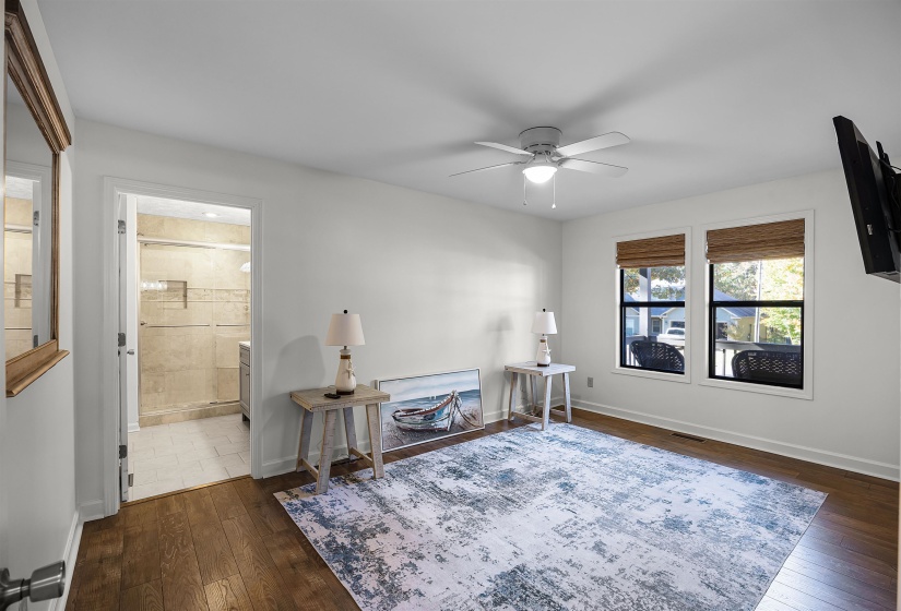 Living area with dark wood finished floors and a ceiling fan