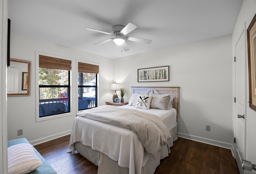 Bedroom with dark wood finished floors and a ceiling fan
