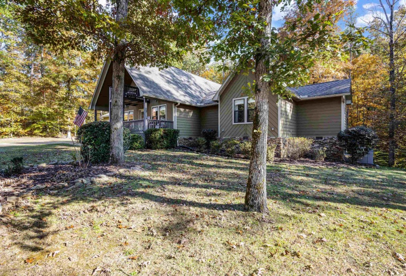 View of front of property featuring a front lawn, a porch, and a shingled roof