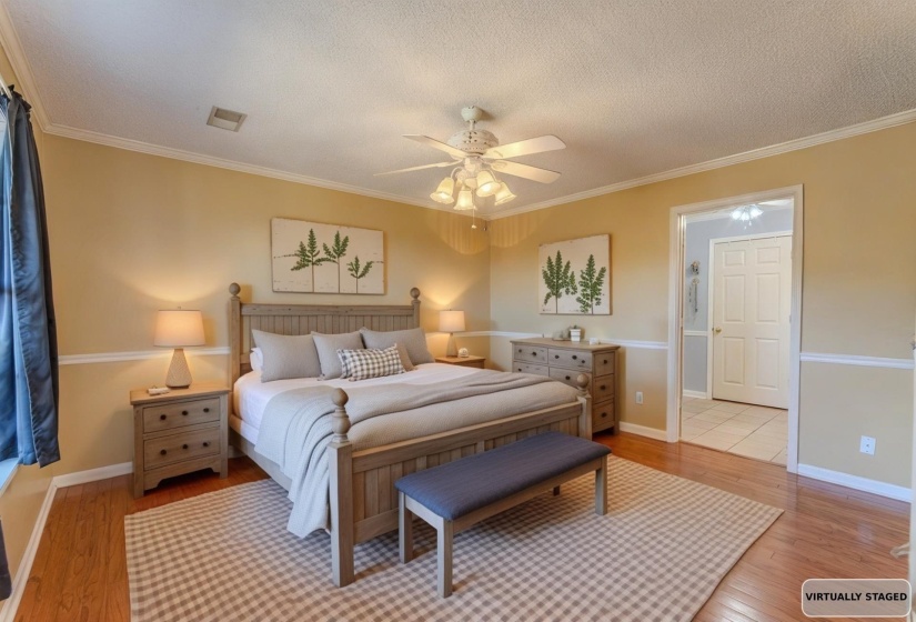 Bedroom featuring light wood finished floors, crown molding, a textured ceiling, and a ceiling fan