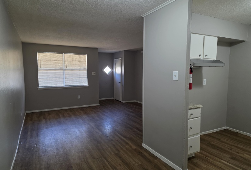 Kitchen featuring white cabinetry, dark wood finished floors, and a textured ceiling