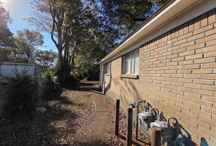 View of side of home with brick siding