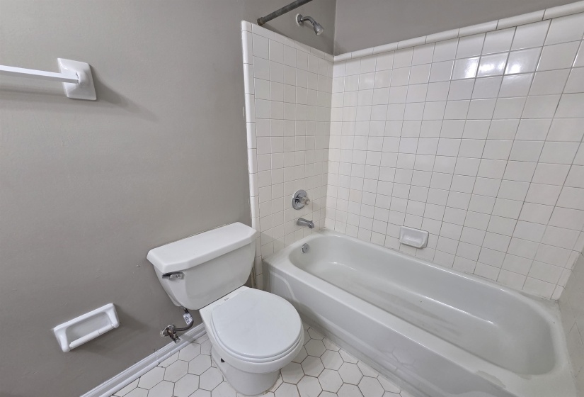 Bathroom featuring tile patterned flooring and bathtub / shower combination