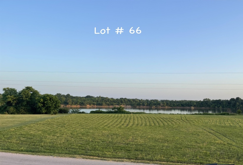View of grassy yard with a water view and a view of rural / pastoral area
