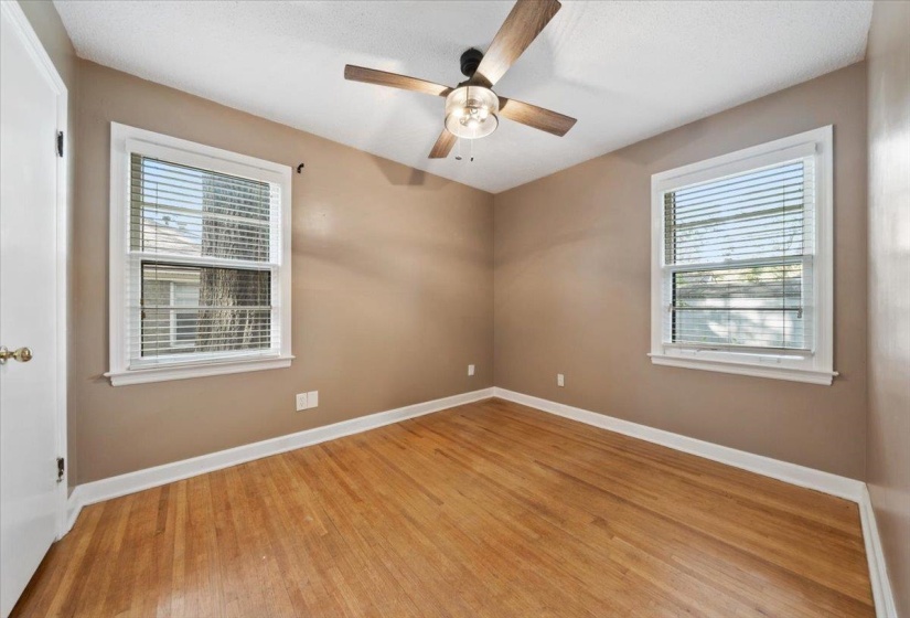 Unfurnished room featuring light wood-style flooring and a ceiling fan