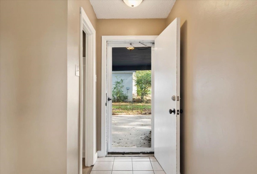 Entryway with tile patterned floors and a textured ceiling
