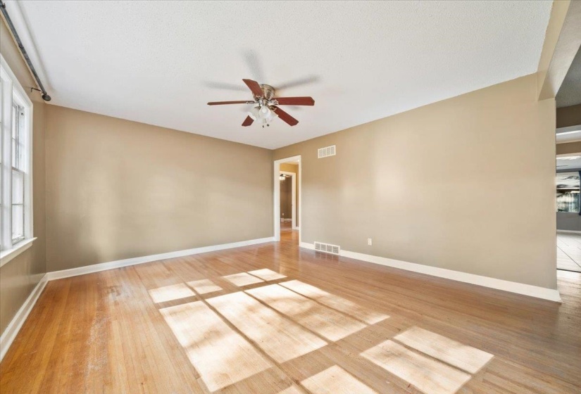Spare room featuring a ceiling fan and light wood-style flooring