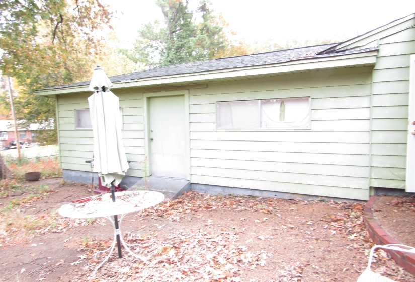 Property entrance featuring roof with shingles