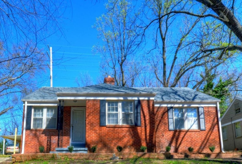 Bungalow with brick siding and a chimney