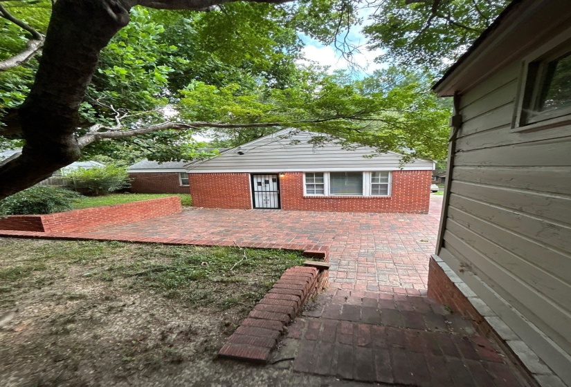 Back of property featuring a patio area and brick siding