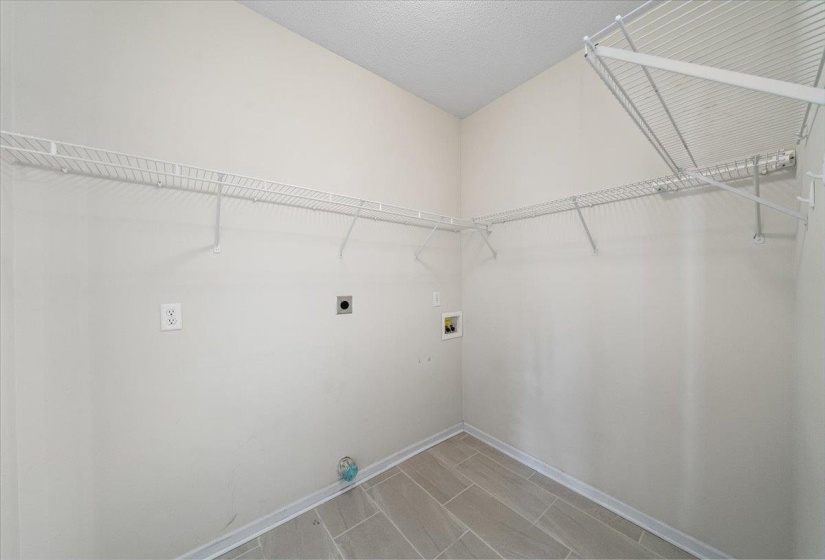 Laundry room with washer hookup, a textured ceiling, and electric dryer hookup