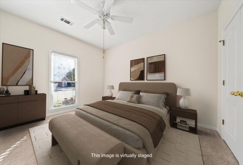 Bedroom with light colored carpet, ceiling fan, and a textured ceiling