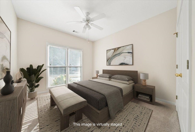 Bedroom with light colored carpet and ceiling fan