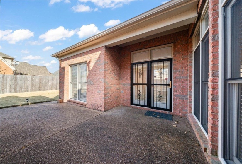 Property entrance featuring a patio and brick siding
