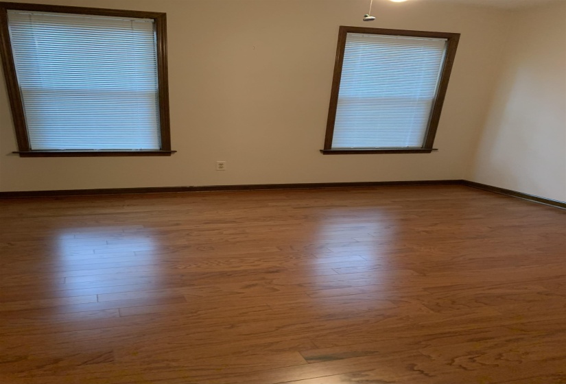 Spare room with baseboards and light wood-type flooring