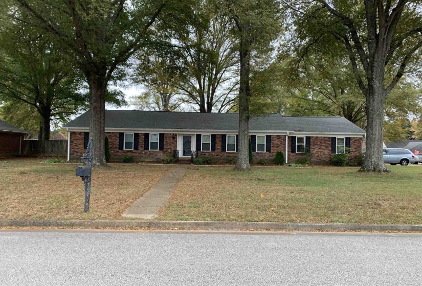 Ranch-style home featuring a front yard and brick siding