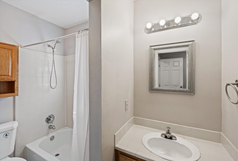 Bathroom featuring shower / bath combo and vanity
