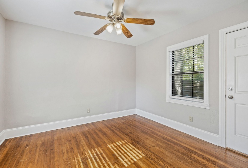 Spare room with wood finished floors and ceiling fan