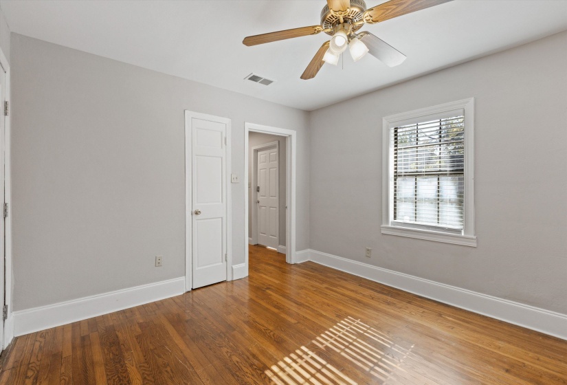 Unfurnished bedroom with light wood-style floors and a ceiling fan